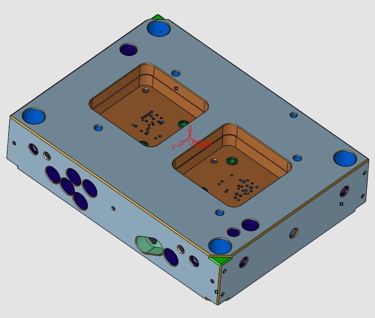 Placa de molde con dos cavidades en la que cada tipo de bolsillo y agujero aparece pintado de un color distinto
